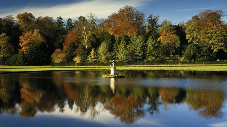 Late Autumn colours reflected in the water of Moon Pond at Studley Royal Water Garden, North Yorkshire
